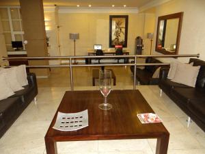 a living room with a wine glass on a table at Diamond Hotel in Rio de Janeiro