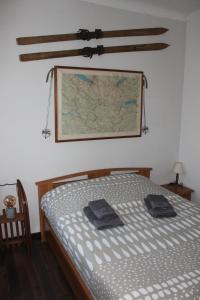 a bedroom with a bed and a map on the wall at Appartement Le Savoisien in Chamonix