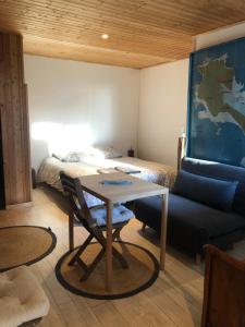 a room with a bed and a table and a couch at La Mer & La Dune in LʼÉpine