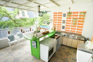 a kitchen with a green counter and a balcony at INNI Homestay in Malang