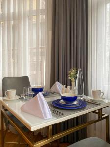 a table with blue bowls and plates on it at Ozkaya Apartments Galata in Istanbul