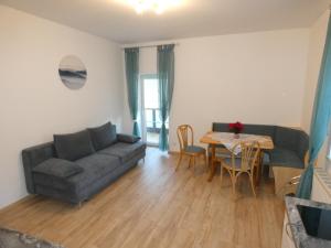 a living room with a couch and a table at Gästezimmer Gombotz in Etmissl