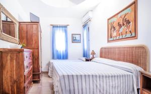 a bedroom with two beds and a dresser at Residence del Sole in Lampedusa