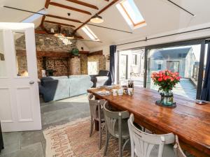 a dining room with a wooden table and chairs at Dairy Lane Cottage in Bunclody