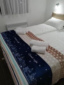 a bed with a comforter and pillows on it at Gorštak-Šeha in Jahorina