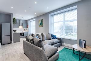 a living room with a couch and a table at Murray Nest #2 - TV in Every Bedroom! in Llanelli