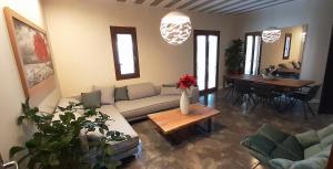 a living room with a couch and a table at Andros 4 All Seasons Villas & Suites in Andros