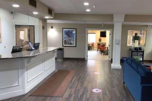 a lobby with a counter and a living room at Comfort Inn in Garden City