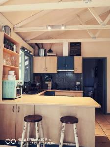a kitchen with a stove top oven and a counter top at Kalimna Woods Cottages in Lakes Entrance
