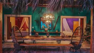 a dining room with a wooden table and chairs at Casa Awakening, Beach-front in El Cuyo