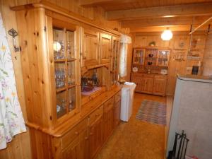 a large kitchen with wooden cabinets and a stove at Almhütte Seeberg in Turnau