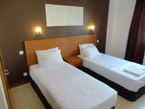 Postel nebo postele na pokoji v ubytování Inn Luanda