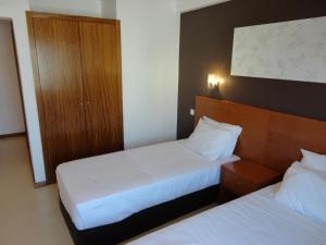 Postel nebo postele na pokoji v ubytování Inn Luanda