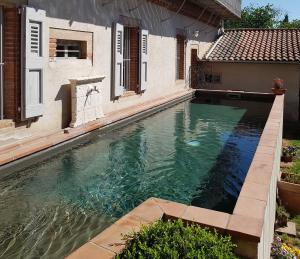 a swimming pool in front of a house at Chez Louise in Albi