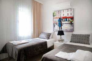 a bedroom with two beds and a painting on the wall at Dadya Villa 1 - Villa with private pool - 750m distance to the beach in Datca