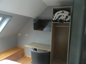 a room with a desk in a attic at at-PACIFIC-HOTEL in Wavre