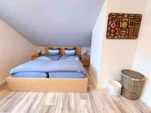 sypialnia z łóżkiem z niebieską pościelą i niebieskimi poduszkami w obiekcie Ferienwohnung Seestern 21 w mieście Bremerhaven