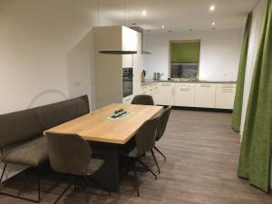 a kitchen and dining room with a wooden table and chairs at Suot Crapalb in Samnaun