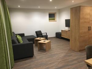 a living room with a couch and a tv at Suot Crapalb in Samnaun