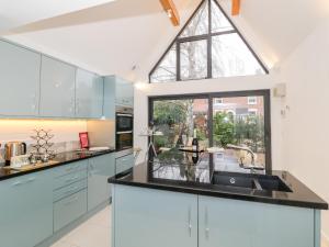 a kitchen with a sink and a large window at Little Mornington in Malvern Link