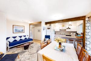 a kitchen and living room with a table and a couch at Beach Retreat -- Lower Retreat in Newport