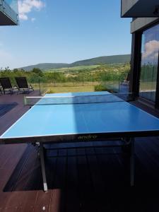 a ping pong table on the deck of a house at Zlaten Briz Villa in Osenovo