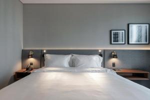 Postel nebo postele na pokoji v ubytování LK Design Hotel Florianópolis