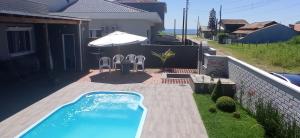 a swimming pool in the backyard of a house at Casa Esquina do Mar in São Francisco do Sul