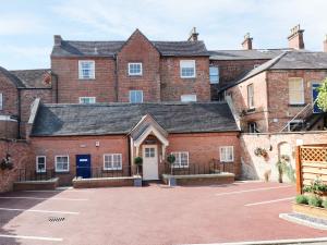 a large red brick building with a parking lot at Manifold Dale in Ashbourne