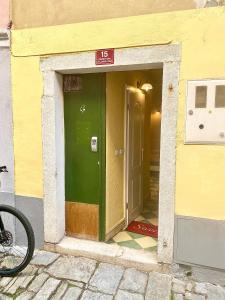 an entrance to a building with a green door at Cosy Little Love Nest in Piran in Piran