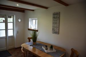 a dining room with a wooden table with a plant on it at Ferienwohnung/Haus in Welzin in Damshagen +6 photos