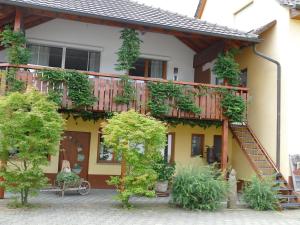 a house with a wooden deck on the side of it at Ferienwohnung Lichtblick in Friesenheim