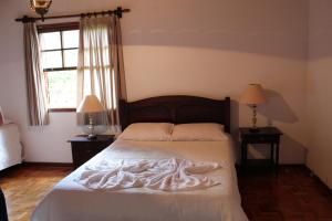 En eller flere senge i et værelse på Casa Aconchegante no Capivari