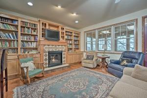 a living room with a fireplace and a tv at Lake Michigan Waterfront Home 1 Mile to Downtown! in Douglas