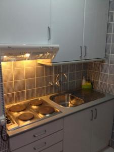 a kitchen with a sink and a counter top at Apartamento Praia do Alvor in Alvor