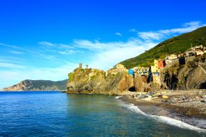 a group of houses on a cliff next to the water at Vernazza Vacation in Vernazza