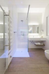 a bathroom with a glass shower and a sink at B&B Gassa D'amante in Vieste