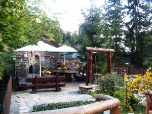 a patio with a table and a stone fireplace at Apartment-in-Wiesa in Thermalbad Wiesenbad