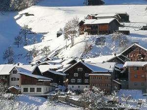 a town covered in snow with buildings at B&B Gafaller in Jenaz