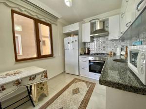 a kitchen with white appliances and a counter top at Trabzon Seaside in Trabzon