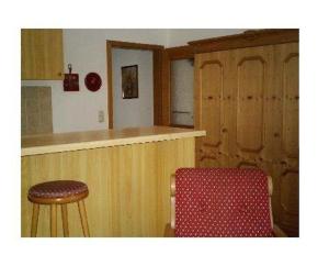 a kitchen with a counter and a bar with a stool at Haus-Alphorn-Wohnung-15 in Oberstdorf