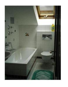 a bathroom with a bath tub and a toilet at Haus-Alphorn-Wohnung-15 in Oberstdorf