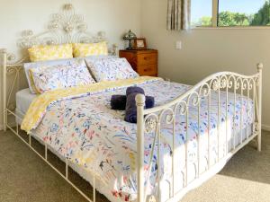 a bedroom with a white bed with a white frame at Hideaway on Fort in Cambridge
