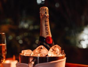 a bottle of champagne in a bucket on a table at CASA EMILIA B&B Boutique in Mexico City