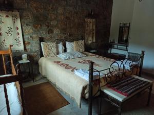 
a bedroom with a bed, a desk, and a painting on the wall at Casa da Azenha in Sortelha
