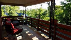 a screened in porch with a chair and a table at Cozy Convenience, Private Home 5mins to Biltmore in Asheville