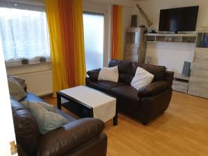 a living room with two couches and a coffee table at Ferienwohnung Mörlenbach in Mörlenbach