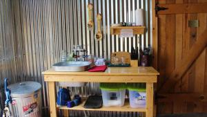 a wooden table with a counter with a sink at Canyonlands Barn Cabin with Loft, Full Kitchen, Dining Area for Large Groups in Verdure +48 photos