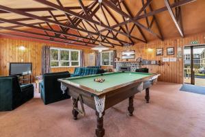 a living room with a pool table in it at Sportsmans Lodge Turangi in Turangi