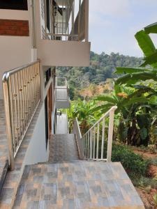 a stairway leading up to a building with trees at DOI TUNG Anisa Homestay in Chiang Rai